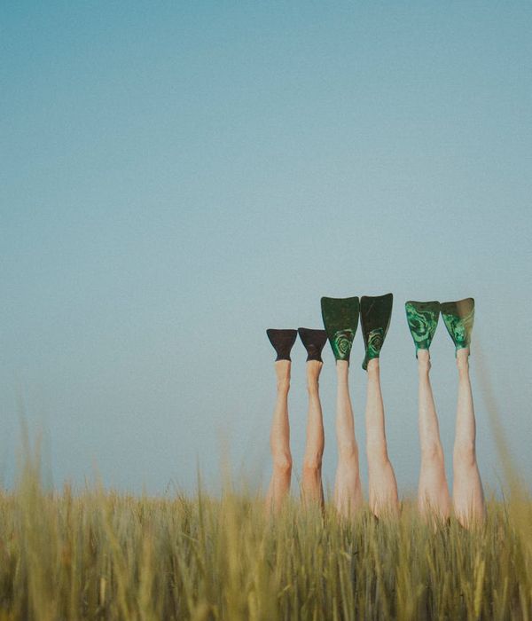 Person standing in a balanced yoga tree pose against a minimalist background.